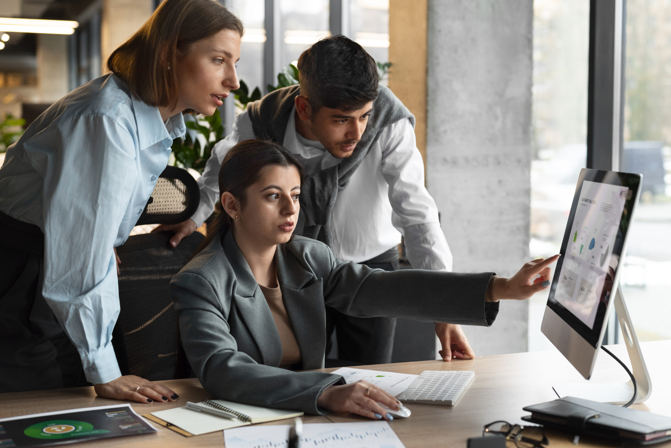 Consulting professionals reviewing sustainability and business performance data in a modern office